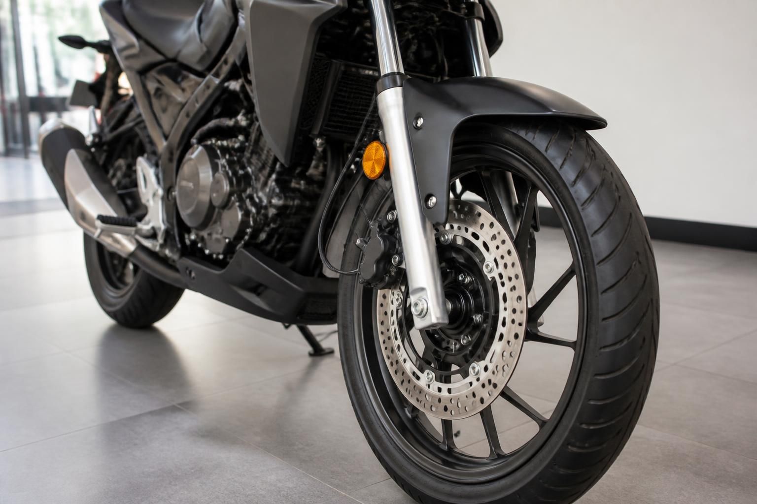 Well-maintained used motorcycle ready for sale in a bright indoor setting.